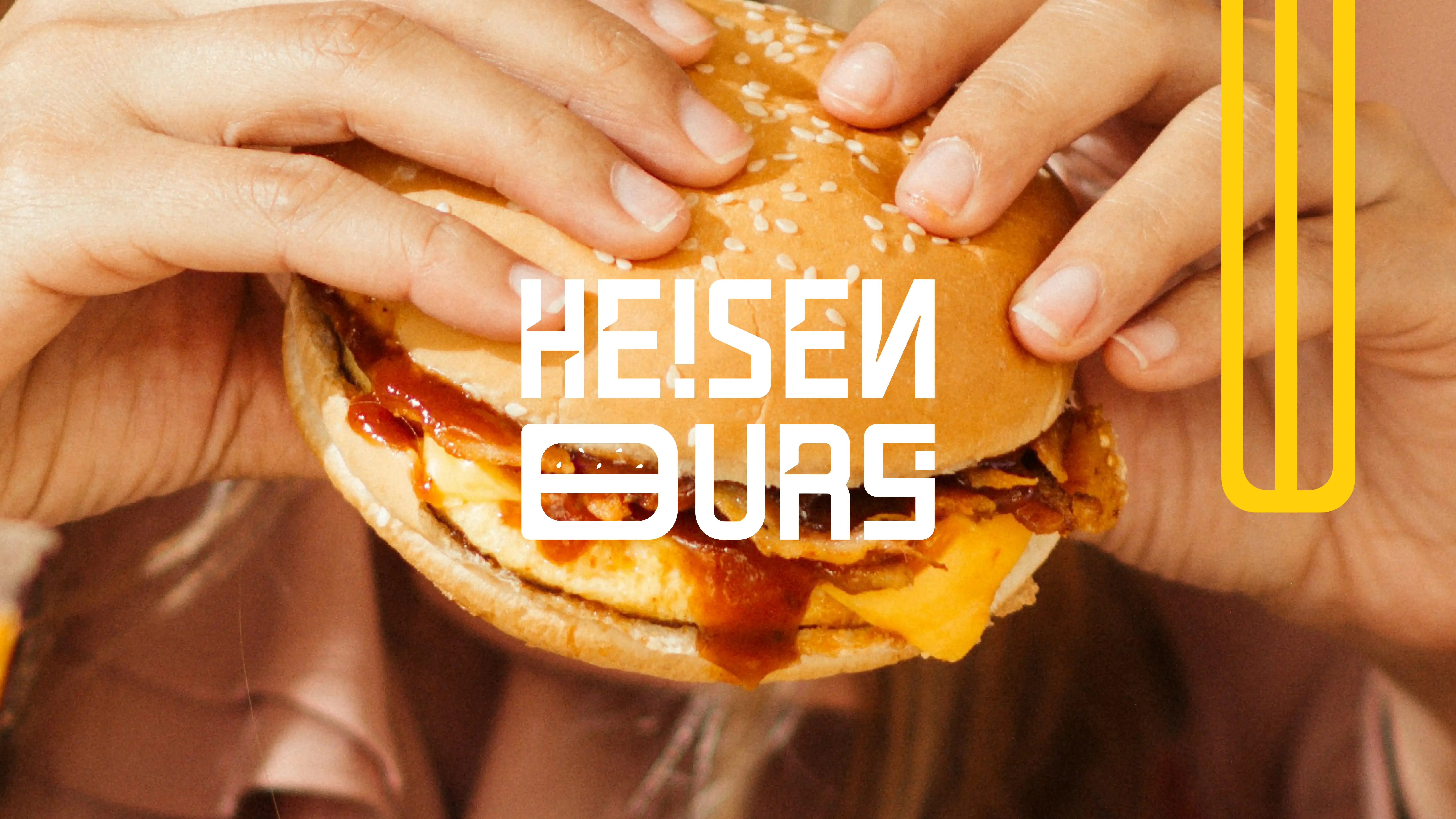 Several hands share a burger beneath the white Heisenburg wordmark and yellow vertical-line device.