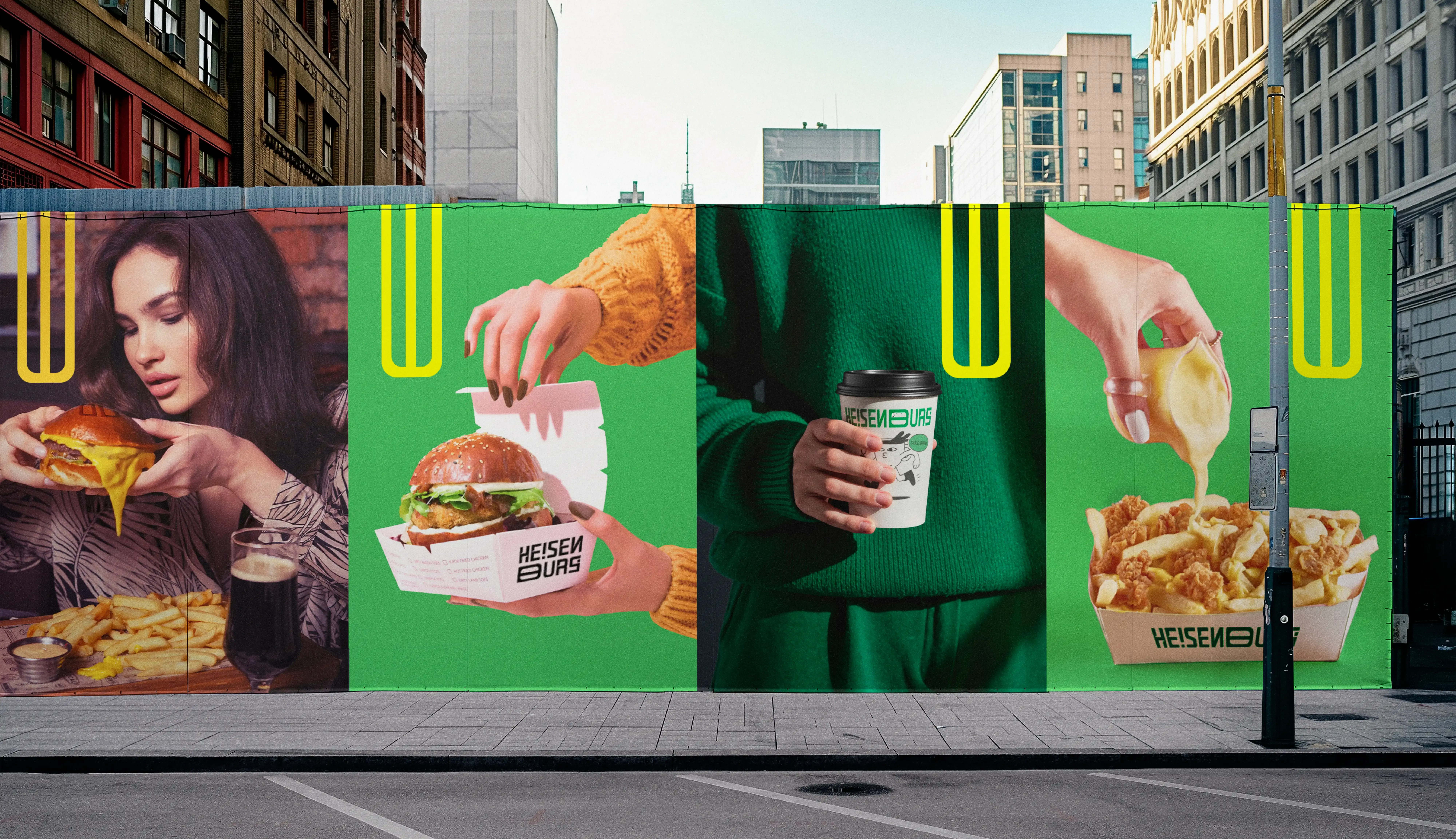 Large Heisenburg outdoor billboard spanning a city wall with burger, packaging, drink and fries imagery in the green and yellow system.