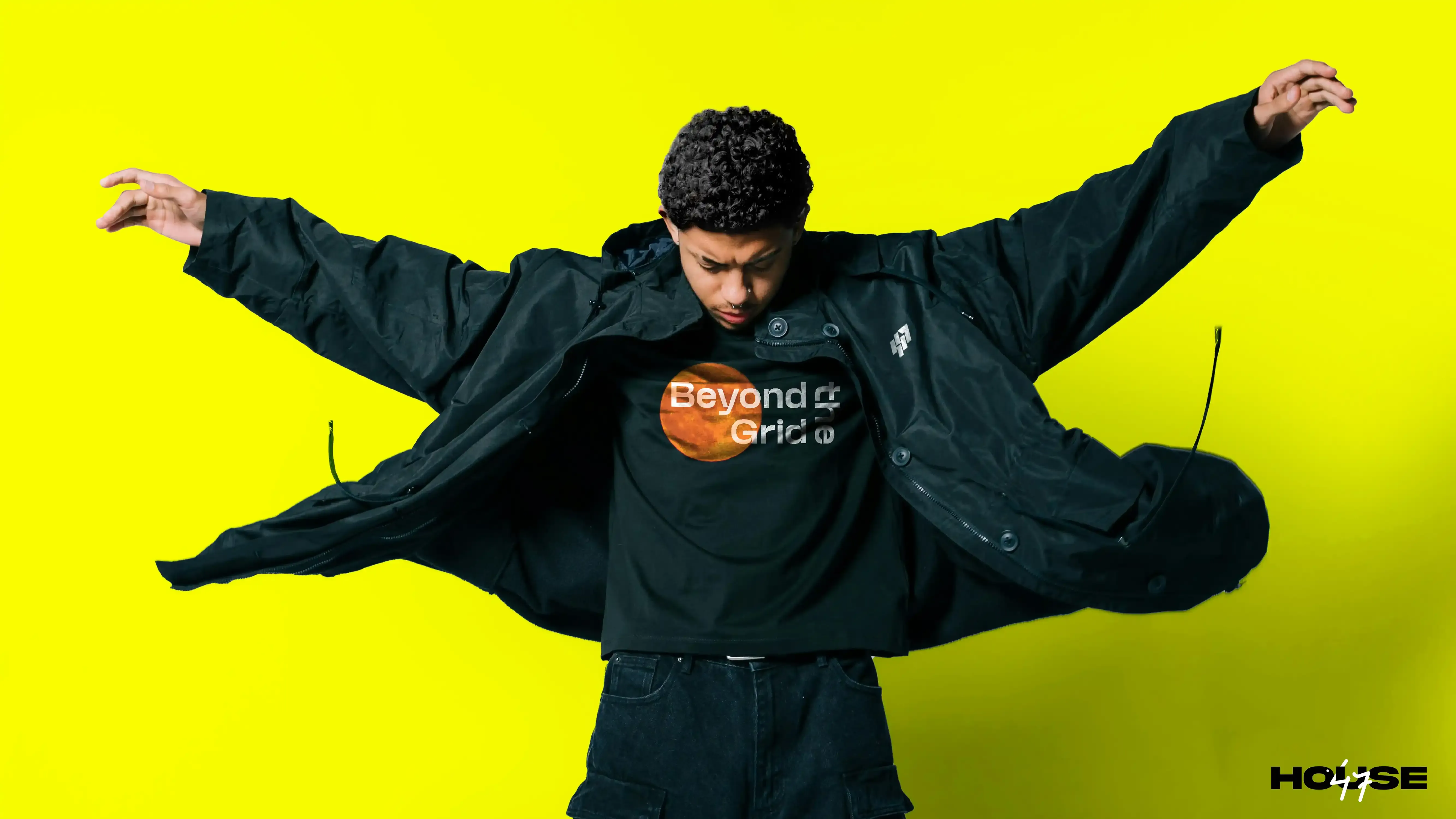 House47 campaign model in black streetwear against an electric-yellow background.
